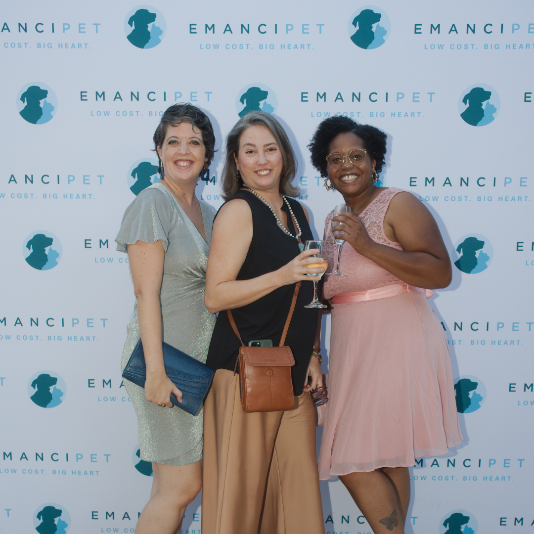 Photo of friends posing in front of Emancipet backdrop at the 2022 Austin Emancipet gala