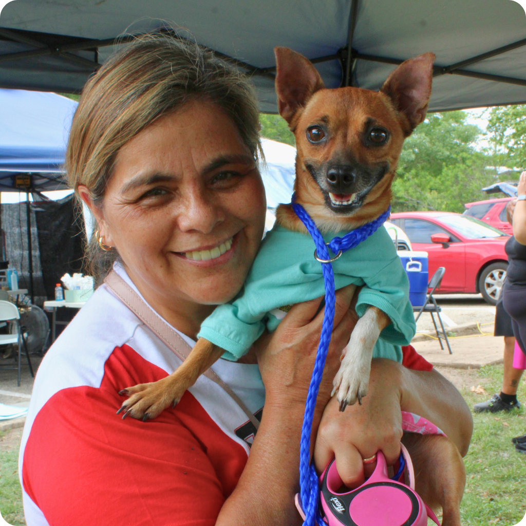 A client and her chihuahua smile and wait for their Healthy Pet Services visit for free and low-cost services during our Austin "Free Days" Mobile Clinic.